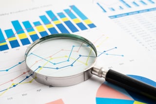 Report and magnifying glass_Sasirin Pamai